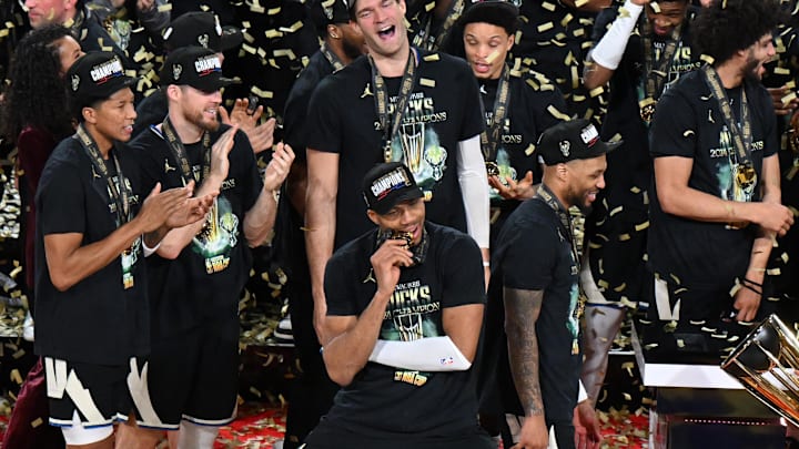 Dec 17, 2024; Las Vegas, Nevada, USA; Milwaukee Bucks forward Giannis Antetokounmpo (34) bites his medal and celebrates with players and staff after winning the Emirates NBA Cup championship game against the Oklahoma City Thunder at T-Mobile Arena. Mandatory Credit: Candice Ward-Imagn Images
