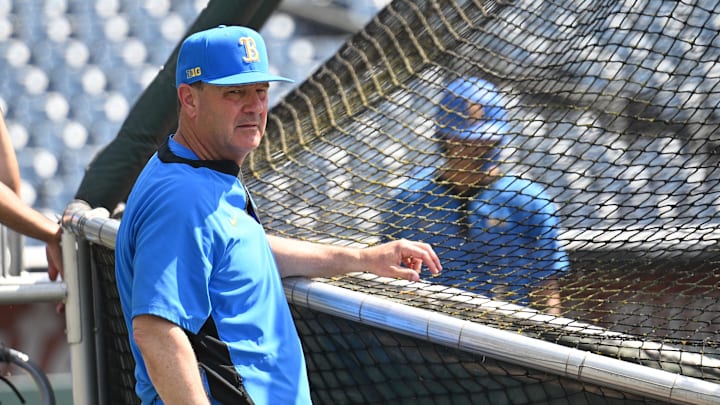 Jun 14, 2025; Omaha, Neb, USA; UCLA Bruins head coach John Savage watches the team warm up before the game against the Murray State Races at Charles Schwab Field. Mandatory Credit: Steven Branscombe-Imagn Images Jun 14, 2025; Omaha, Neb, USA; UCLA Bruins head coach John Savage watches the team warm up before the game against the Murray State Races at Charles Schwab Field. Mandatory Credit: Steven Branscombe-Imagn Images