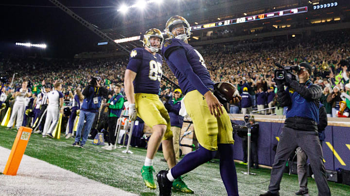 Notre Dame quarterback Kenny Minchey celebrates after scoring a touchdown in the second half against Syracuse.