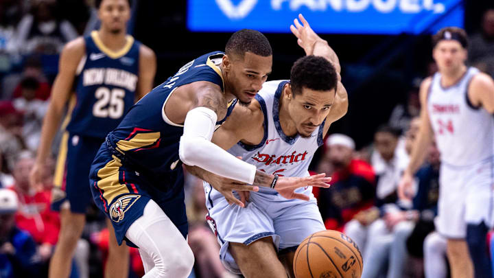 Jan 3, 2025; New Orleans, Louisiana, USA;  New Orleans Pelicans guard Dejounte Murray (5) steals the ball from Washington Wizards guard Malcolm Brogdon (15) during the second half at Smoothie King Center. Mandatory Credit: Stephen Lew-Imagn Images