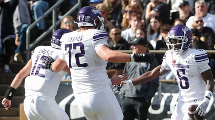 Northwestern Wildcats running back Joseph Himon II (6) celebrates with Northwestern Wildcats quarterback Jack Lausch (12) and Northwestern Wildcats offensive lineman Caleb Tiernan (72) after scoring Saturday, Nov. 2, 2024, during the NCAA football game against the Purdue Boilermakers at Ross-Ade Stadium in West Lafayette, Ind.