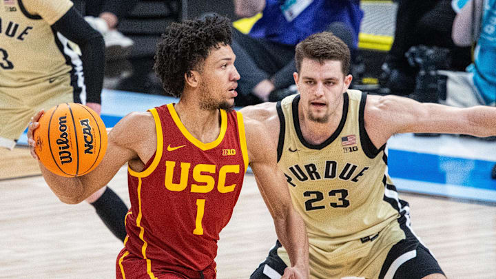 Mar 13, 2025; Indianapolis, IN, USA; USC Trojans guard Desmond Claude (1) passes the ball while Purdue Boilermakers forward Camden Heide (23) defends in the second half at Gainbridge Fieldhouse. Mandatory Credit: Trevor Ruszkowski-Imagn Images