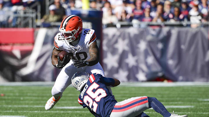 Oct 26, 2025; Foxborough, Massachusetts, USA;  Cleveland Browns running back Quinshon Judkins (10) runs with the ball against New England Patriots cornerback Marcus Jones (25) during the first quarter at Gillette Stadium. Mandatory Credit: Bob DeChiara-Imagn Images