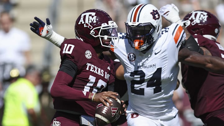 Sep 27, 2025; College Station, Texas, USA; Texas A&M Aggies quarterback Marcel Reed (10) looks for an open receiver as Auburn Tigers defensive end Keyron Crawford (24) applies defensive pressure during the second quarter at Kyle Field. Mandatory Credit: Troy Taormina-Imagn Images