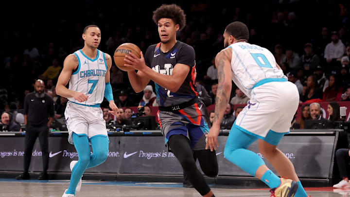 Nov 30, 2023; Brooklyn, New York, USA; Brooklyn Nets forward Cameron Johnson (2) looks to pass the ball against Charlotte Hornets guard Bryce McGowens (7) and forward Miles Bridges (0) during the first quarter at Barclays Center. Mandatory Credit: Brad Penner-Imagn Images