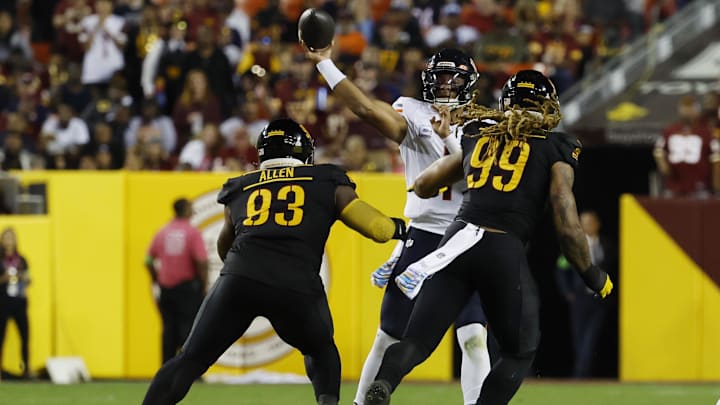 Oct 5, 2023; Landover, Maryland, USA; Chicago Bears quarterback Justin Fields (1) passes the ball under pressure from Washington Commanders defensive tackle Jonathan Allen (93) and Commanders defensive end Chase Young (99) during the second quarter at FedExField. 