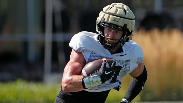 Purdue Boilermakers defensive back Dillon Thieneman (31) returns a punt Tuesday, Aug. 13, 2024, during Purdue football practice at Bimel Outdoor Practice Complex in West Lafayette, Ind.