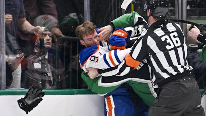 Mar 12, 2026; Dallas, Texas, USA; Dallas Stars center Justin Hryckowian (49) fights Edmonton Oilers center Connor McDavid (97) during the second period at the American Airlines Center. Mandatory Credit: Jerome Miron-Imagn Images