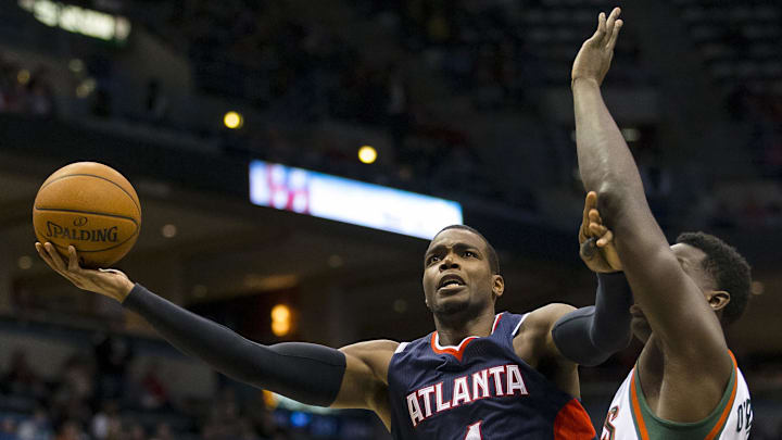 Dec 27, 2014; Milwaukee, WI, USA; Atlanta Hawks forward Paul Millsap (4) shoots around Milwaukee Bucks forward Johnny O'Bryant III (3) during the third quarter at BMO Harris Bradley Center. Mandatory Credit: Jeff Hanisch-Imagn Images