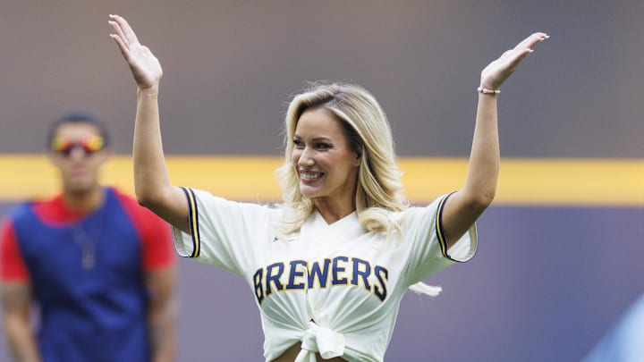 Jun 16, 2023; Milwaukee, Wisconsin, USA;  Paige Spiranac waves to the crowd after throwing out a first pitch prior to the game between the Pittsburgh Pirates and Milwaukee Brewers at American Family Field. 