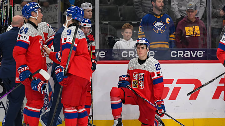 Jan 5, 2026; St. Paul, Minnesota, USA; Czechia defensemen Vladimir Dravecky (9) comforts forward Adam Novotny (24) as Czechia forward Stepan Hoch (25) looks on after falling to Sweden in the final of the 2026 IIHF World Junior Championship ice hockey tournament at Grand Casino Arena. Mandatory Credit: Nick Wosika-Imagn Images