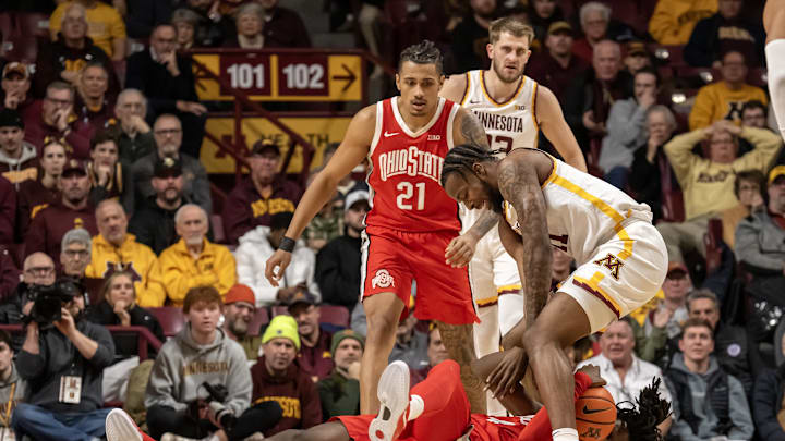 Jan 6, 2025; Minneapolis, Minnesota, USA;  Ohio State Buckeyes forward Aaron Bradshaw (4) and Minnesota Golden Gophers guard Femi Odukale (11) battle for a loose ball during the first half at Williams Arena. Mandatory Credit: Nick Wosika-Imagn Images