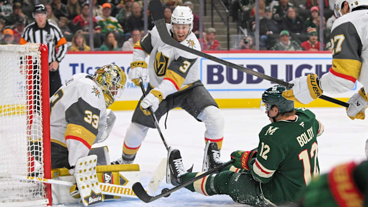 May 1, 2025; Saint Paul, Minnesota, USA;  Vegas Golden Knights goalie Adin Hill (33) makes a save on Minnesota Wild forward Matt Boldy (12) as defenseman Brayden McNabb (3) defends during the second period in game six of the first round of the 2025 Stanley Cup Playoffs at Xcel Energy Center. Mandatory Credit: Nick Wosika-Imagn Images