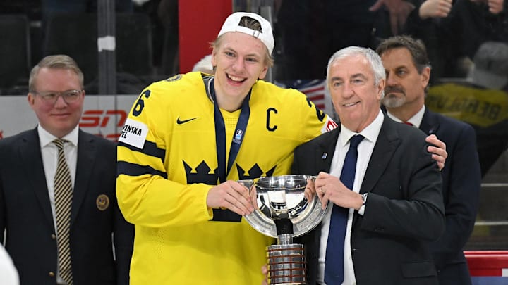 Jan 5, 2026; St. Paul, Minnesota, USA; Sweden forward Jack Berglund (26) is presented with the first place trophy by IIHF President Luc Tardif after defeating Czechia in the final of the 2026 IIHF World Junior Championship ice hockey tournament at Grand Casino Arena. Jan 5, 2026; St. Paul, Minnesota, USA; Sweden forward Jack Berglund (26) is presented with the first place trophy by IIHF President Luc Tardif after defeating Czechia in the final of the 2026 IIHF World Junior Championship ice hockey tournament at Grand Casino Arena.