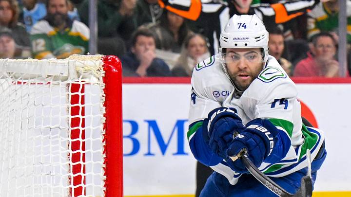 Apr 2, 2026; Saint Paul, Minnesota, USA;  Vancouver Canucks forward Jake DeBrusk (74) knocks the puck out of the air and into the net against the Minnesota Wild for a power play goal during the first period at Grand Casino Arena. Mandatory Credit: Nick Wosika-Imagn Images