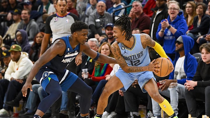 Memphis Grizzlies guard Ja Morant (12) protects the ball as Minnesota Timberwolves forward Anthony Edwards (1) defends during the second quarter at Target Center. Mandatory Credit: Nick Wosika-Imagn Images Memphis Grizzlies guard Ja Morant (12) protects the ball as Minnesota Timberwolves forward Anthony Edwards (1) defends during the second quarter at Target Center. Mandatory Credit: Nick Wosika-Imagn Images