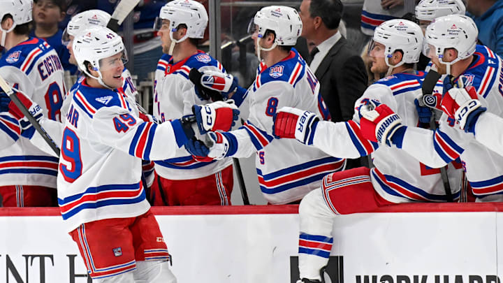 Mar 14, 2026; Saint Paul, Minnesota, USA;  New York Rangers forward Jaroslav Chmelar (49) celebrates his goal against the Minnesota Wild with defensemen Adam Fox (23) during the second period at Grand Casino Arena. Mandatory Credit: Nick Wosika-Imagn Images
