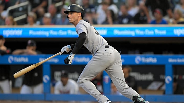 Sep 17, 2025; Minneapolis, Minnesota, USA;  New York Yankees outfielder Cody Bellinger (35) hits a RBI-single against the Minnesota Twins during the first inning at Target Field. Mandatory Credit: Nick Wosika-Imagn Images

