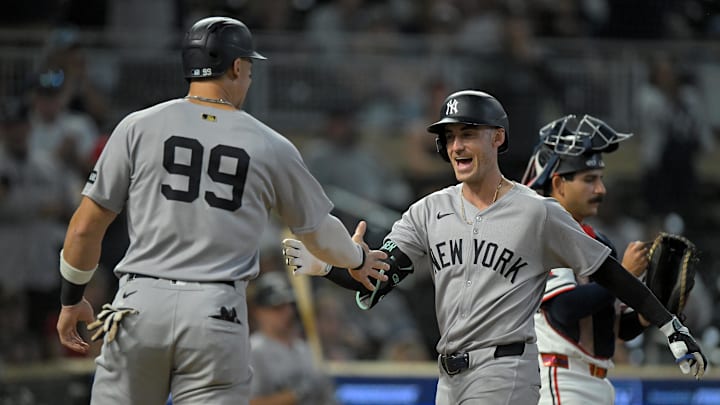 Sep 17, 2025; Minneapolis, Minnesota, USA;  New York Yankees designated hitter Aaron Judge (99) congratulates outfielder Cody Bellinger (35) on his two-run home run against the Minnesota Twins during the ninth inning at Target Field. Mandatory Credit: Nick Wosika-Imagn Images