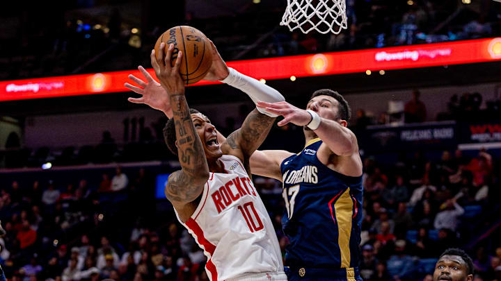 Mar 6, 2025; New Orleans, Louisiana, USA;  Houston Rockets forward Jabari Smith Jr. (10) dribbles against New Orleans Pelicans forward Zion Williamson (1) and center Karlo Matkovic (17) during the second half at Smoothie King Center. Mandatory Credit: Stephen Lew-Imagn Images