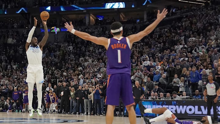 Nov 17, 2024; Minneapolis, Minnesota, USA; Minnesota Timberwolves forward Julius Randle (30) hits a game-winning three-pointer against the Phoenix Suns as time expires in the fourth quarter at Target Center. Mandatory Credit: Nick Wosika-Imagn Images