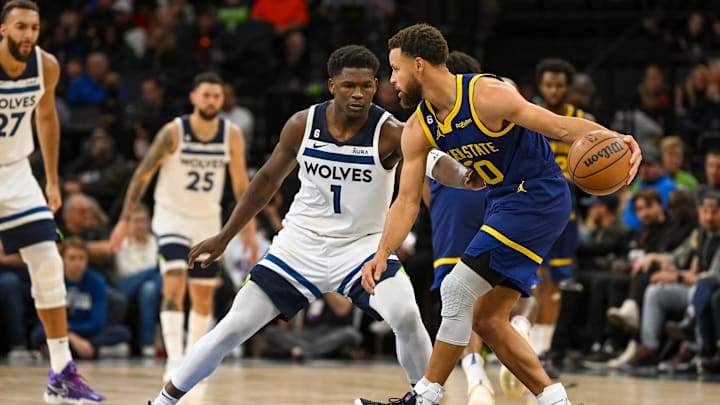 Nov 27, 2022; Minneapolis, Minnesota, USA; Golden State Warriors guard Stephen Curry (30) protects the ball from Minnesota Timberwolves forward Anthony Edwards (1) during the second half at Target Center. Mandatory Credit: Nick Wosika-Imagn Image