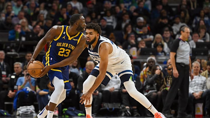 Nov 27, 2022; Minneapolis, Minnesota, USA; Golden State Warriors forward Draymond Green (23) protects the ball as Minnesota Timberwolves center Karl-Anthony Towns (32) defends during the second half at Target Center. Mandatory Credit: Nick Wosika-Imagn Images