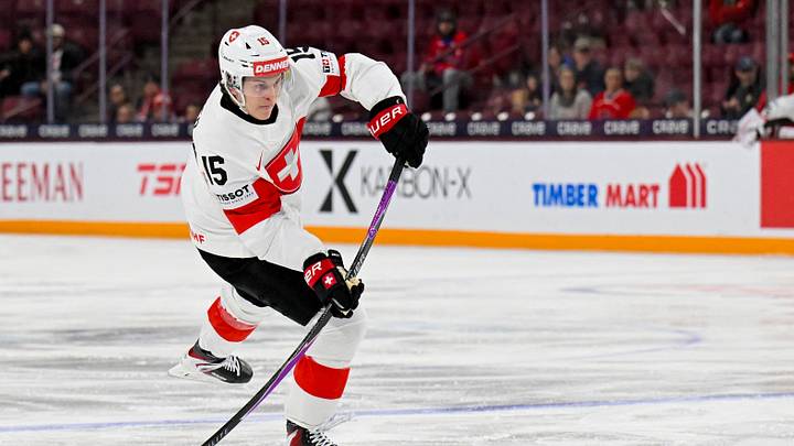 Jan 2, 2026; Minneapolis, Minnesota, USA; Switzerland forward Lars Steiner (15) shoots the puck against Czechia during the first period in the quarterfinals of the 2026 IIHF World Junior Championship at 3M Arena. Mandatory Credit: Nick Wosika-Imagn Images