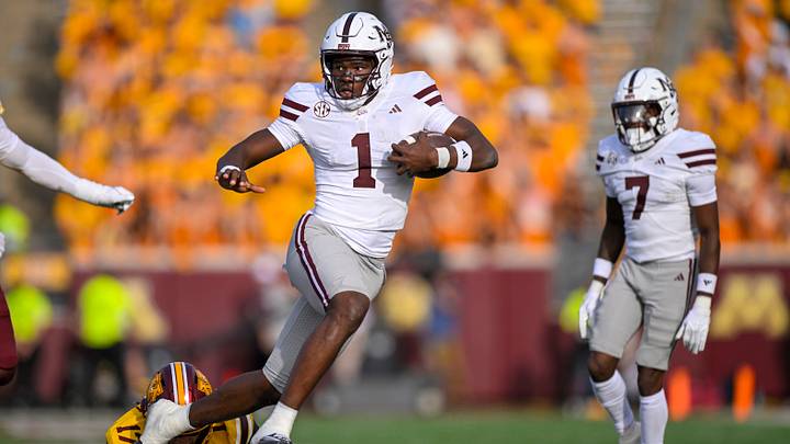 Sep 12, 2026; Minneapolis, Minnesota, USA;  Mississippi State Bulldogs quarterback Kamario Taylor (1) breaks the tackle attempt of Minnesota Golden Gophers defensive back John Nestor (17) during the fourth quarter at Huntington Bank Stadium.  Mandatory Credit: Nick Wosika-Imagn Images