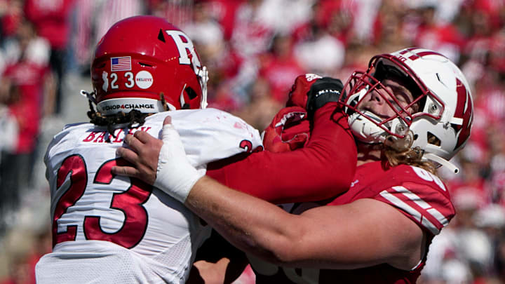 Wisconsin offensive lineman Joe Huber (60) blocks Rutgers defensive lineman Wesley Bailey (23) during the second quarter of their game Saturday, October 7, 2023 at Camp Randall Stadium in Madison, Wisconsin.