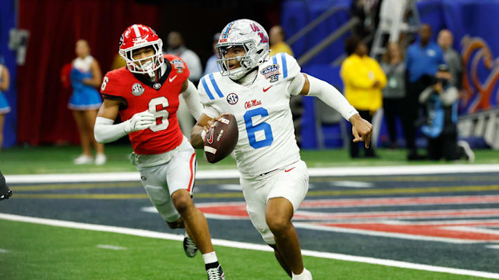 Jan 1, 2026; New Orleans, LA, USA; Mississippi Rebels quarterback Trinidad Chambliss (6) scrambles with the ball under pressure from Georgia Bulldogs defensive back Daylen Everette (6) in the fourth quarter during the 2026 Sugar Bowl and quarterfinal game of the College Football Playoff at Caesars Superdome. Mandatory Credit: Geoff Burke-Imagn Images