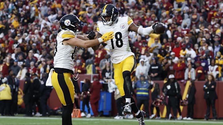 Nov 10, 2024; Landover, Maryland, USA; Pittsburgh Steelers wide receiver Mike Williams (18) celebrates with Steelers tight end Pat Freiermuth (88) after catching a touchdown pass against the Washington Commanders late in the second half at Northwest Stadium. Mandatory Credit: Geoff Burke-Imagn Images