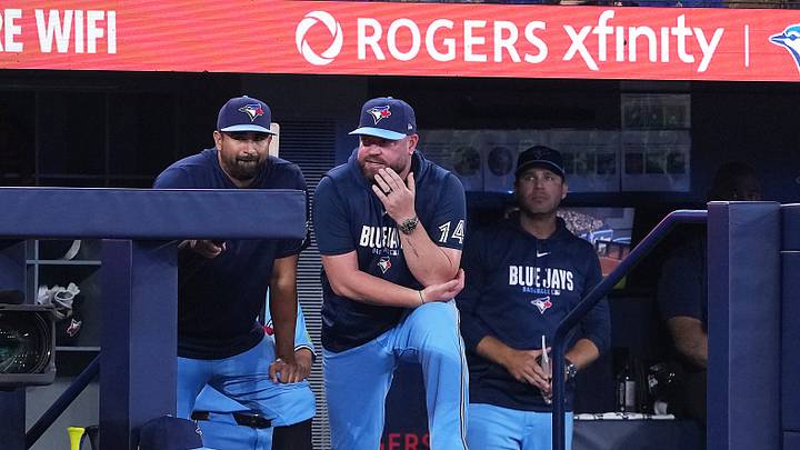 Aug 2, 2026; Toronto, Ontario, CAN; Toronto Blue Jays manager John Schneider (14) watches the play from the dugout against the St. Louis Cardinals during the eighth inning at Rogers Centre. Mandatory Credit: Nick Turchiaro-Imagn Images