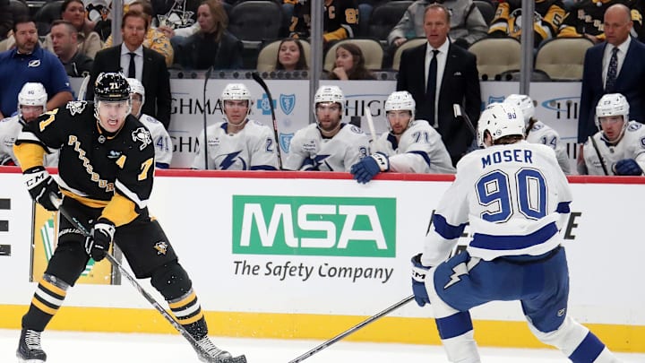 Nov 19, 2024; Pittsburgh, Pennsylvania, USA;  Pittsburgh Penguins center Evgeni Malkin (71) skates up ice with the puck as Tampa Bay Lightning defenseman J.J. Moser (90) defends during the third period at PPG Paints Arena. Mandatory Credit: Charles LeClaire-Imagn Images