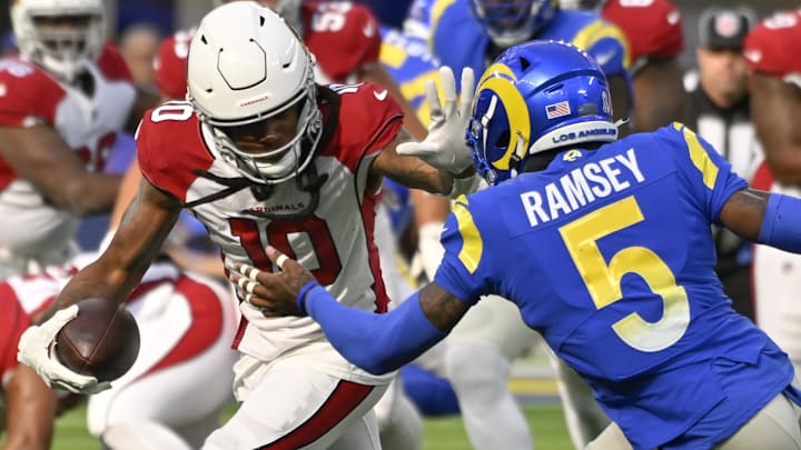 Nov 13, 2022; Inglewood, California, USA; Arizona Cardinals wide receiver DeAndre Hopkins (10) grabs the facemark of Los Angeles Rams cornerback Jalen Ramsey (5) after catching a short pass in the second quarter at SoFi Stadium. Mandatory Credit: Robert Hanashiro-Imagn Images