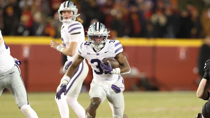 Nov 30, 2024; Ames, Iowa, USA;  Kansas State Wildcats running back DJ Giddens (31) runs the football against the Iowa State Cyclones in the first quarter at at Jack Trice Stadium. Mandatory Credit: Reese Strickland-Imagn Images