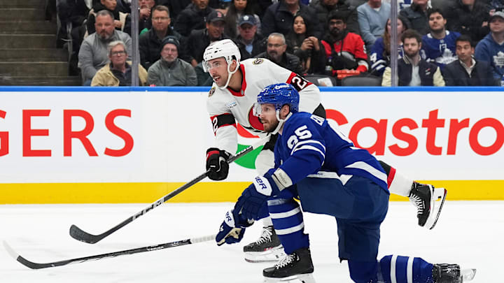 Nov 12, 2024; Toronto, Ontario, CAN; Ottawa Senators right wing Michael Amadio (22) scores past Toronto Maple Leafs defenseman Oliver Ekman-Larsson (95) during the second period at Scotiabank Arena. Mandatory Credit: Nick Turchiaro-Imagn Images