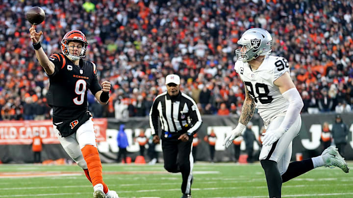 Cincinnati Bengals quarterback Joe Burrow (9) throws as Las Vegas Raiders defensive end Maxx Crosby (98) pressures in the second quarter during an NFL AFC wild-card playoff game, Saturday, Jan. 15, 2022, at Paul Brown Stadium in Cincinnati.

Las Vegas Raiders At Cincinnati Bengals Jan 15 Afc Wild Card Game