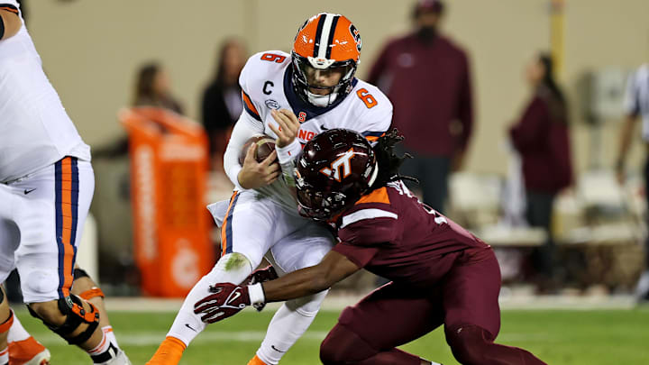 Oct 26, 2023; Blacksburg, Virginia, USA; Virginia Tech Hokies safety Keonta Jenkins (7) tackles Syracuse Orange quarterback Garrett Shrader (6) during the second quarter at Lane Stadium. Mandatory Credit: Peter Casey-Imagn Images
