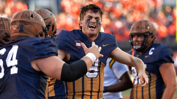 Oct 19, 2024; Champaign, Illinois, USA;  Illinois Fighting Illini quarterback Luke Altmyer (9) celebrates after scoring a touchdown against the Michigan Wolverines during the second half at Memorial Stadium. Mandatory Credit: Ron Johnson-Imagn Images