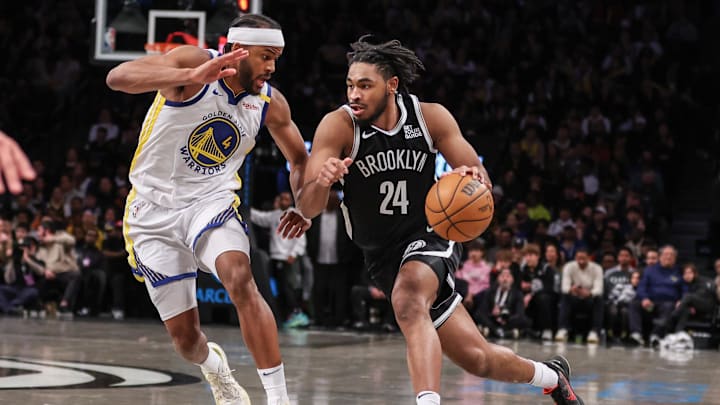 Mar 6, 2025; Brooklyn, New York, USA;  Brooklyn Nets guard Cam Thomas (24) drives past Golden State Warriors guard Moses Moody (4) in the third quarter at Barclays Center. Mandatory Credit: Wendell Cruz-Imagn Images