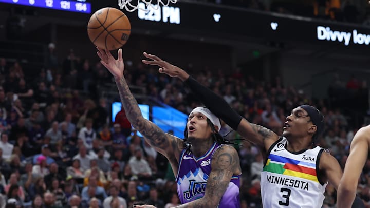 Utah Jazz guard Jordan Clarkson goes to the basket against Minnesota Timberwolves forward Jaden McDaniels. Mandatory Credit: Rob Gray-Imagn Images