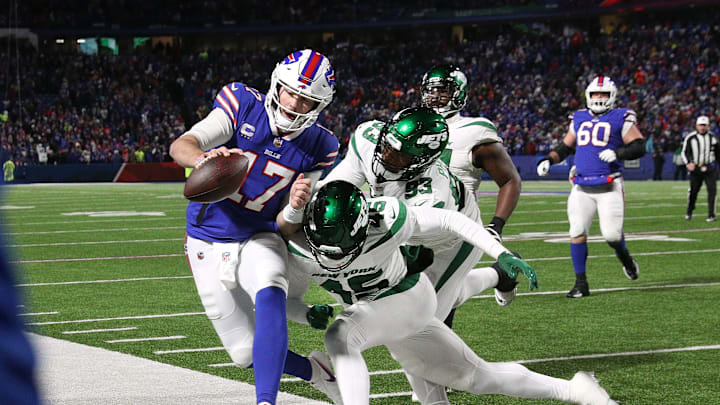 Bills quarterback Josh Allen is hit as he goes out of bounds by Jets Hamsah Nasirildeen. The Bills beat the Jets 27-10 to win the AFC east. Bills quarterback Josh Allen is hit as he goes out of bounds by Jets Hamsah Nasirildeen. The Bills beat the Jets 27-10 to win the AFC east.