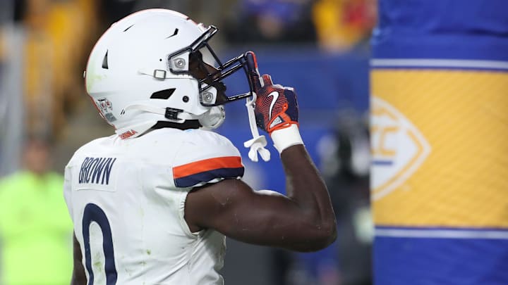 Nov 9, 2024; Pittsburgh, Pennsylvania, USA;  Virginia Cavaliers running back Xavier Brown (0) gestures to the Pittsburgh student section after scoring a touchdown against the Pittsburgh Panthers during the third quarter at Acrisure Stadium. Mandatory Credit: Charles LeClaire-Imagn Images