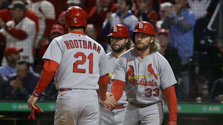 Oct 4, 2022; Pittsburgh, Pennsylvania, USA;  St. Louis Cardinals right fielder Lars Nootbaar (21) and second  baseman Brendan Donovan (33) celebrate after both players scored runs against the Pittsburgh Pirates during the third inning at PNC Park. Mandatory Credit: Charles LeClaire-Imagn Images