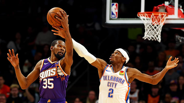 Mar 3, 2024; Phoenix, Arizona, USA; Phoenix Suns forward Kevin Durant (35) and Oklahoma City Thunder guard Shai Gilgeous-Alexander (2) go for the ball during the second quarter at Footprint Center. Mandatory Credit: Mark J. Rebilas-Imagn Images