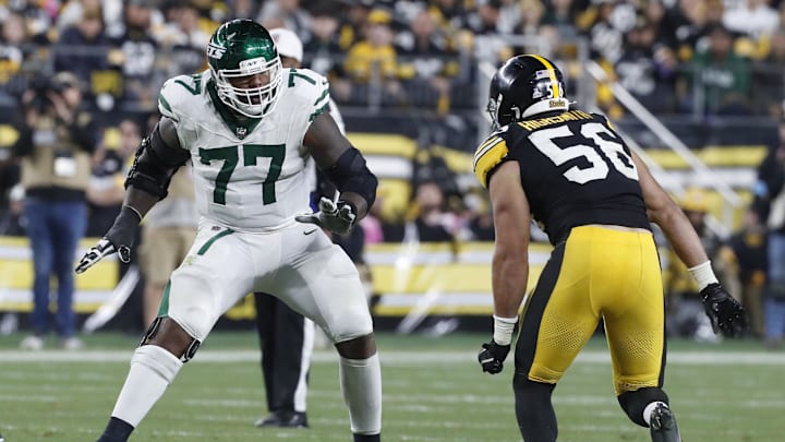 Oct 20, 2024; Pittsburgh, Pennsylvania, USA; New York Jets offensive tackle Tyron Smith (77) blocks against Pittsburgh Steelers linebacker Alex Highsmith (56) at the line of scrimmage during the third quarter at Acrisure Stadium. Mandatory Credit: Charles LeClaire-Imagn Images Oct 20, 2024; Pittsburgh, Pennsylvania, USA; New York Jets offensive tackle Tyron Smith (77) blocks against Pittsburgh Steelers linebacker Alex Highsmith (56) at the line of scrimmage during the third quarter at Acrisure Stadium. Mandatory Credit: Charles LeClaire-Imagn Images