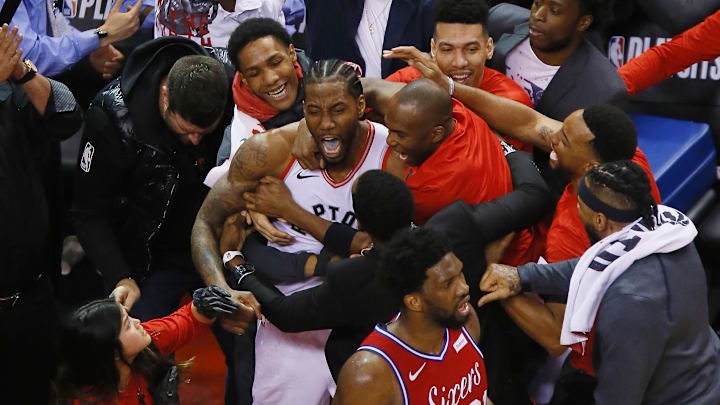 May 12, 2019; Toronto, Ontario, CAN; Toronto Raptors forward Kawhi Leonard (top middle) is congratulated after making the game winning basket against Philadelphia 76ers center Joel Embiid (21) during game seven of the second round of the 2019 NBA Playoffs at Scotiabank Arena. Toronto defeated Philadelphia. Mandatory Credit: John E. Sokolowski-Imagn Images