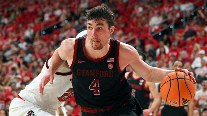 Mar 7, 2026; Raleigh, North Carolina, USA;  Stanford Cardinal forward AJ Rohosy (4) controls the ball around NC State Wolfpack forward Ven-Allen Lubin (22) during the second half at Lenovo Center. Mandatory Credit: Zachary Taft-Imagn Images
