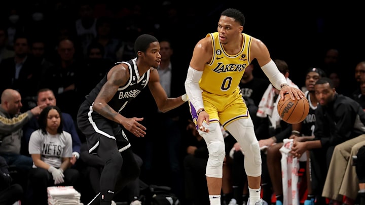 Jan 30, 2023; Brooklyn, New York, USA; Los Angeles Lakers guard Russell Westbrook (0) controls the ball against Brooklyn Nets guard Edmond Sumner (4) during the second quarter at Barclays Center. Mandatory Credit: Brad Penner-Imagn Images